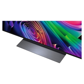 LG OLED evo AI C6 is wall-mounted in a styled living space, featuring an ultra-slim design with narrow bezels, and it displays a riverside cityscape at sunset on screen.