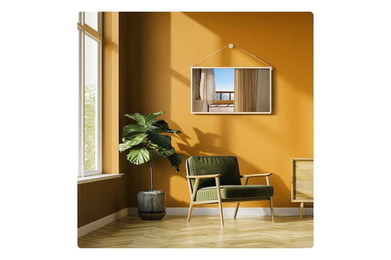 LG StanbyME 2 Max LX6 Taşınabilir Ekran, sıcak tonlara sahip bir odada duvara monte edilmiş bir askı ile perdelerden balkon okyanusu görünümü gösteriyor; sıcak bir iç mekanda esnek yerleştirmeyi ve mekana dekoratif açıdan uyum sağlayabileceğini vurguluyor.