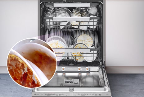 A built-in dishwasher with the door fully open, revealing dirty dishes inside.