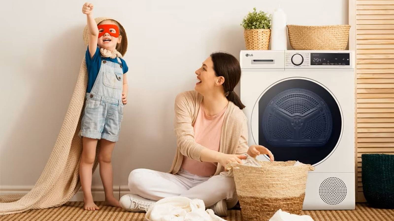 Image of a child and a mother, child raising fist with brown blanket covered, mother smiling at a child.