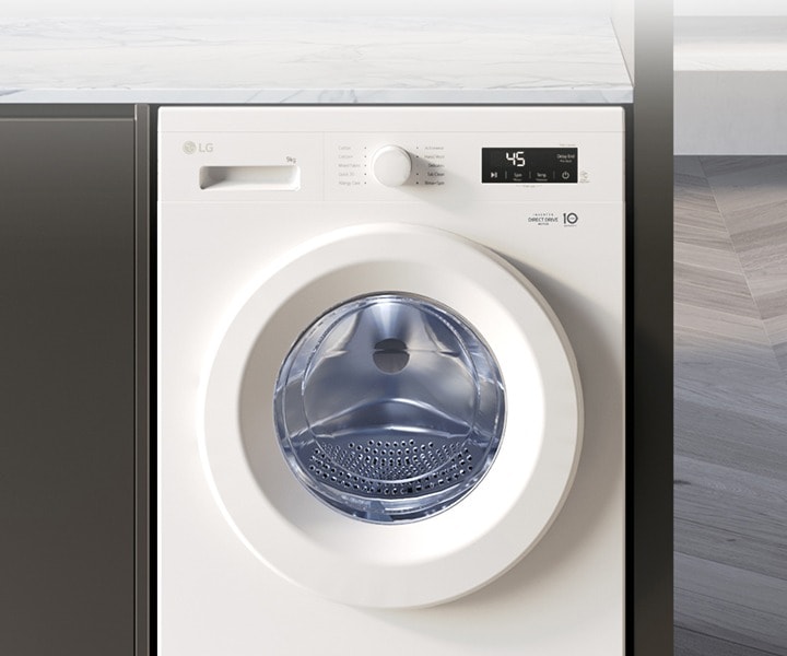 LG front load washing machine installed in a modern kitchen space illustrating the choice between repair or replacement