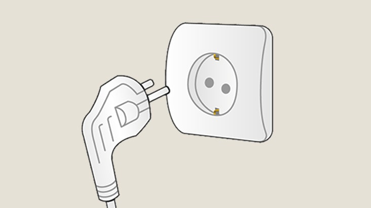 Illustration of a two-pin power plug positioned near a wall socket, showing the plug about to be inserted into the outlet.