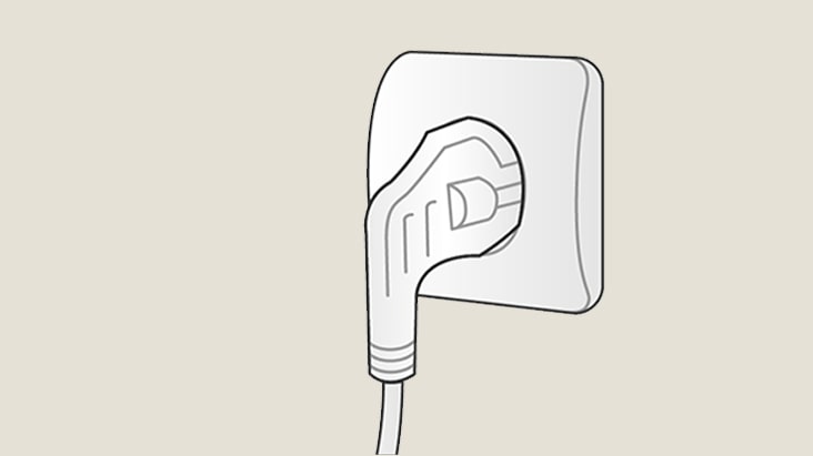 Illustration of a power plug fully inserted into a wall socket, showing a secure electrical connection.