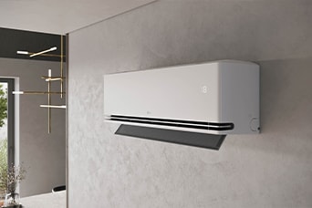 Một chiếc máy điều hòa treo tường màu trắng với cánh đảo gió phía dưới đang mở, được lắp đặt trên bức tường nội thất màu xám có bề mặt vân nổi.