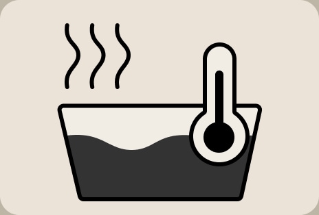 Biểu tượng hướng dẫn nhiệt độ giặt LG cho thấy cài đặt giặt nước ấm với ký hiệu nhiệt kế và vải