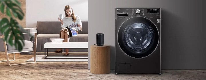 Máy giặt cửa trước LG được đặt trong phòng khách hiện đại với ghế sofa, bàn cà phê và sàn gỗ