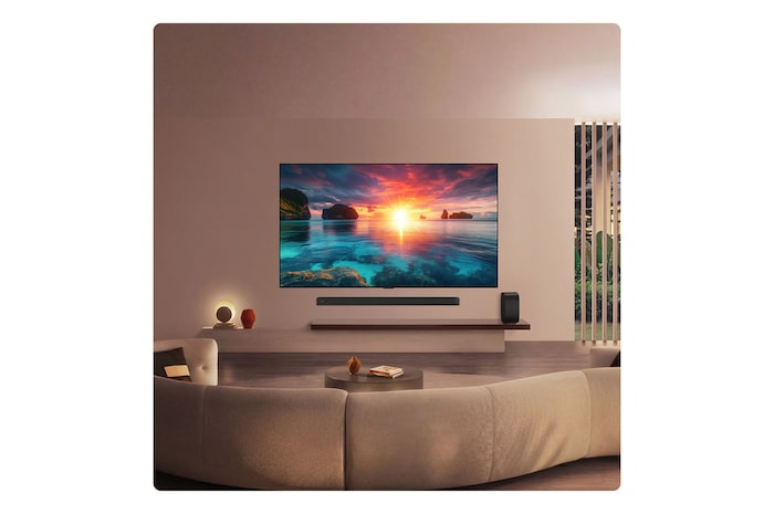 LG OLED evo AI G6 displays a vivid ocean sunset scene, with a soundbar and speaker positioned below the screen, enhancing a calm and atmospheric living space.