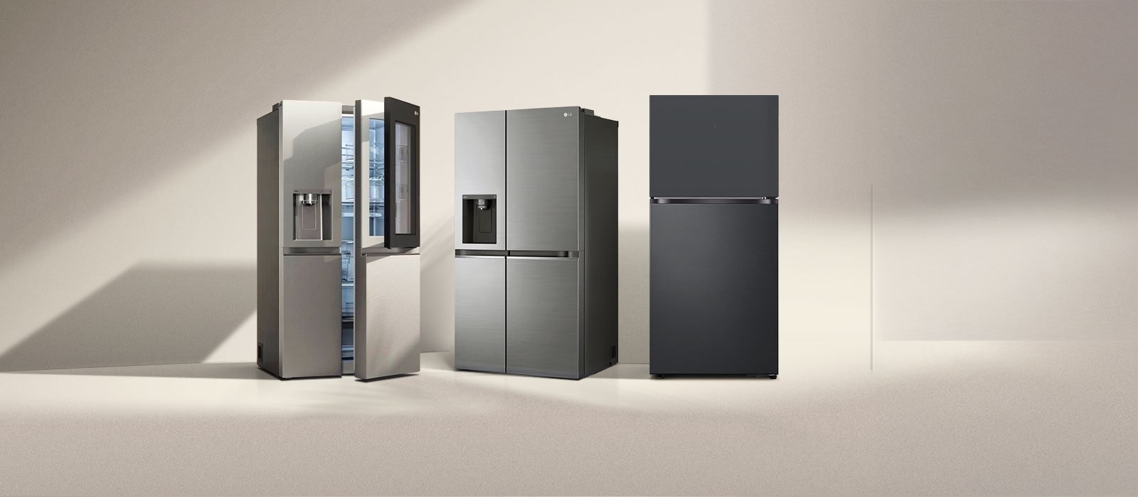 Four LG refrigerator freezers in the sun. Left french door refrigerator with two-door and side-by-side models with one-door next to it.