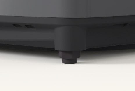 Close up of a washer adjustable foot ensuring stable placement.