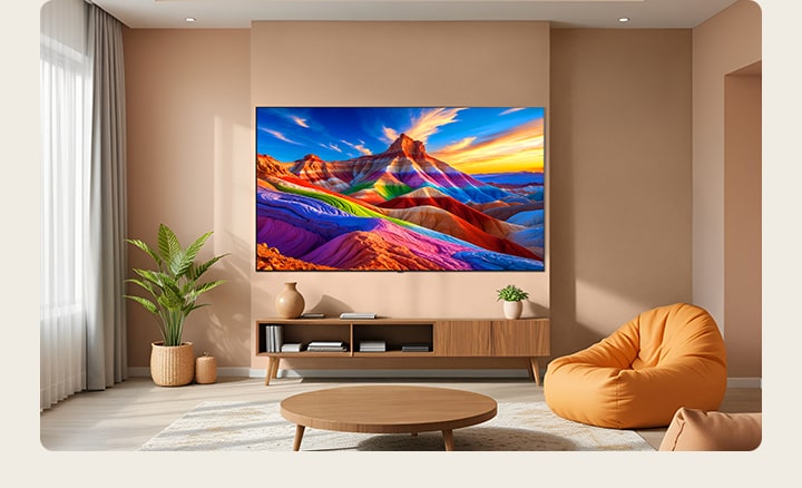 LG OLED AI B6 is wall-mounted in a styled living space, featuring an ultra-slim design with narrow bezels, and it displays a rainbow-toned landscape with layered mountain forms on screen.