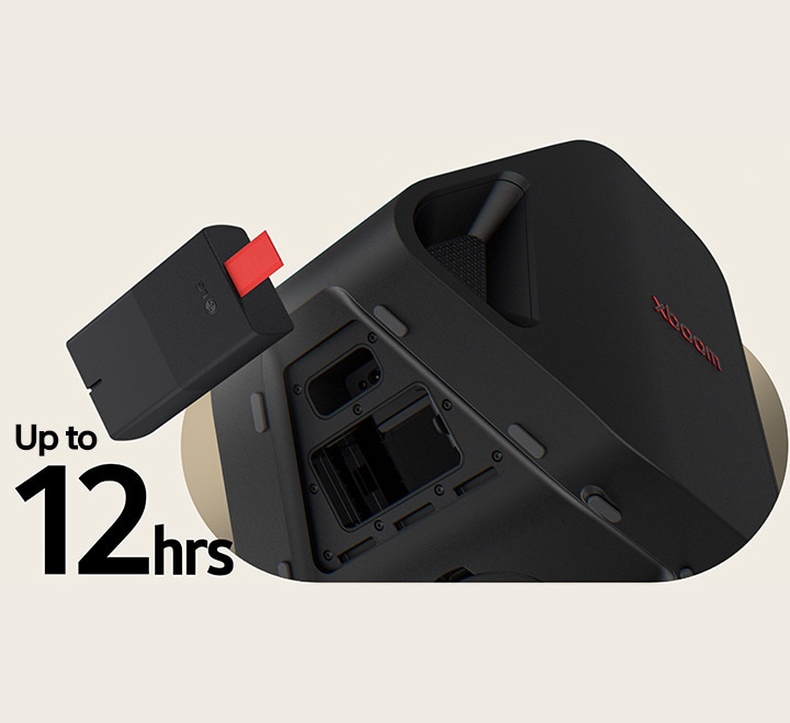 Rear side of Stage 301 is shown with its battert part open. A replaceable battery is hanging on the air right next to the xboom Stage 301.