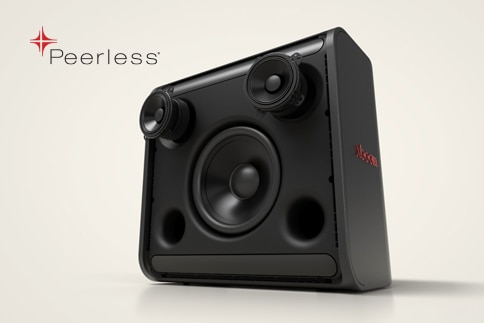 Woman sits indoors relaxing with LG Speaker