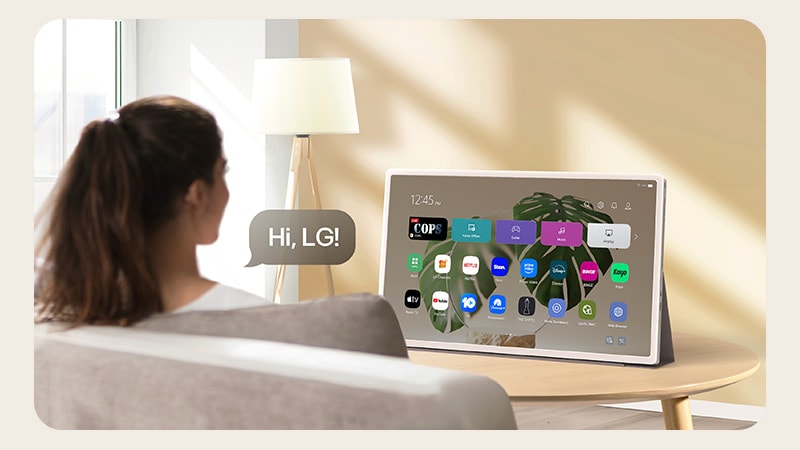 A person using voice recognition on StanbyME 2, a speech bubble is visible with text that reads Hi, LG!