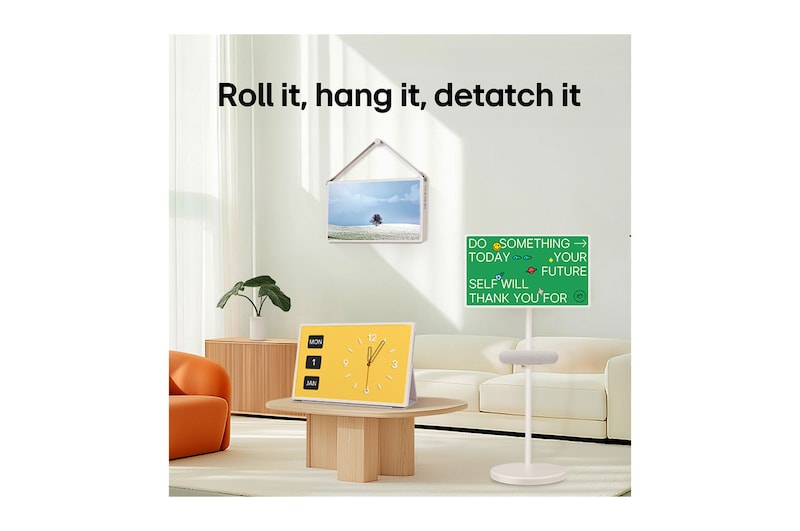 LG StanbyME 2 screens displayed in a modern living room. There is a StanbyME 2 on a stand, one is hung on the wall, and the other is propped up on a table using the folio cover.