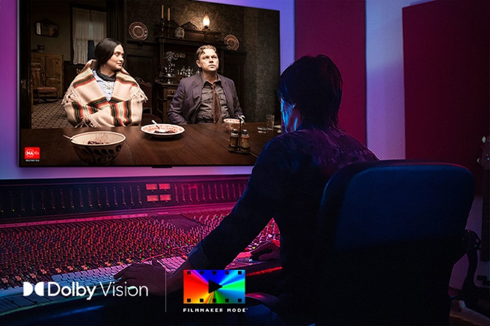 A director in front of a control panel editing the movie "Killers of the Flower Moon" on an LG OLED TV. In the bottom left, the Dolby Vision logo and FILMMAKER MODE logo.