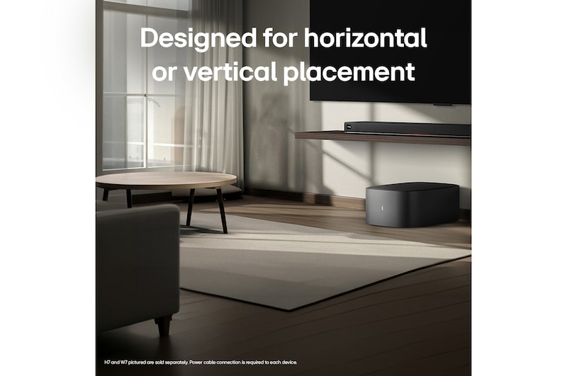 LG Sound Suite W7 woofer placed below a TV with a soundbar, showing easy wireless sound expansion for an immersive home stereo audio system