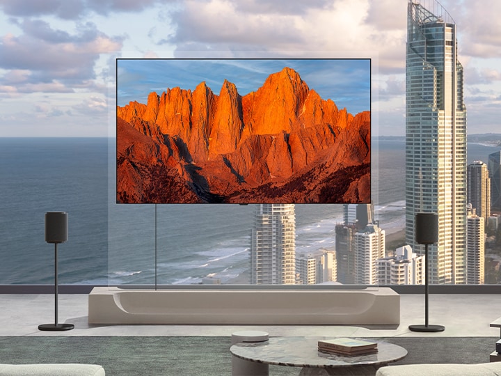 LG OLED evo AI W6 Wallpaper TV featuring Sound Suite with DAFC (Dolby Atmos FlexConnect) shows a wide room with different kinds of speakers placed around the room showing how flexible and customizable Sound Suite can be.