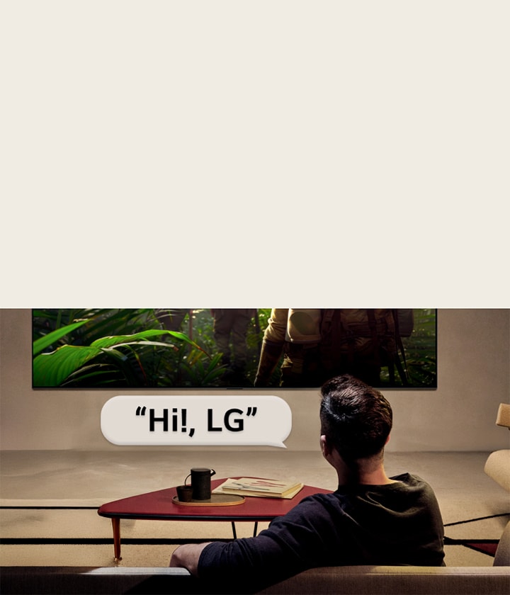 LG OLED evo AI C6 with Far Field Voice Recognition is activated through a voice command as a person seated in a room says “Hi, LG” toward the TV, indicating hands-free voice interaction within the TV interface.
