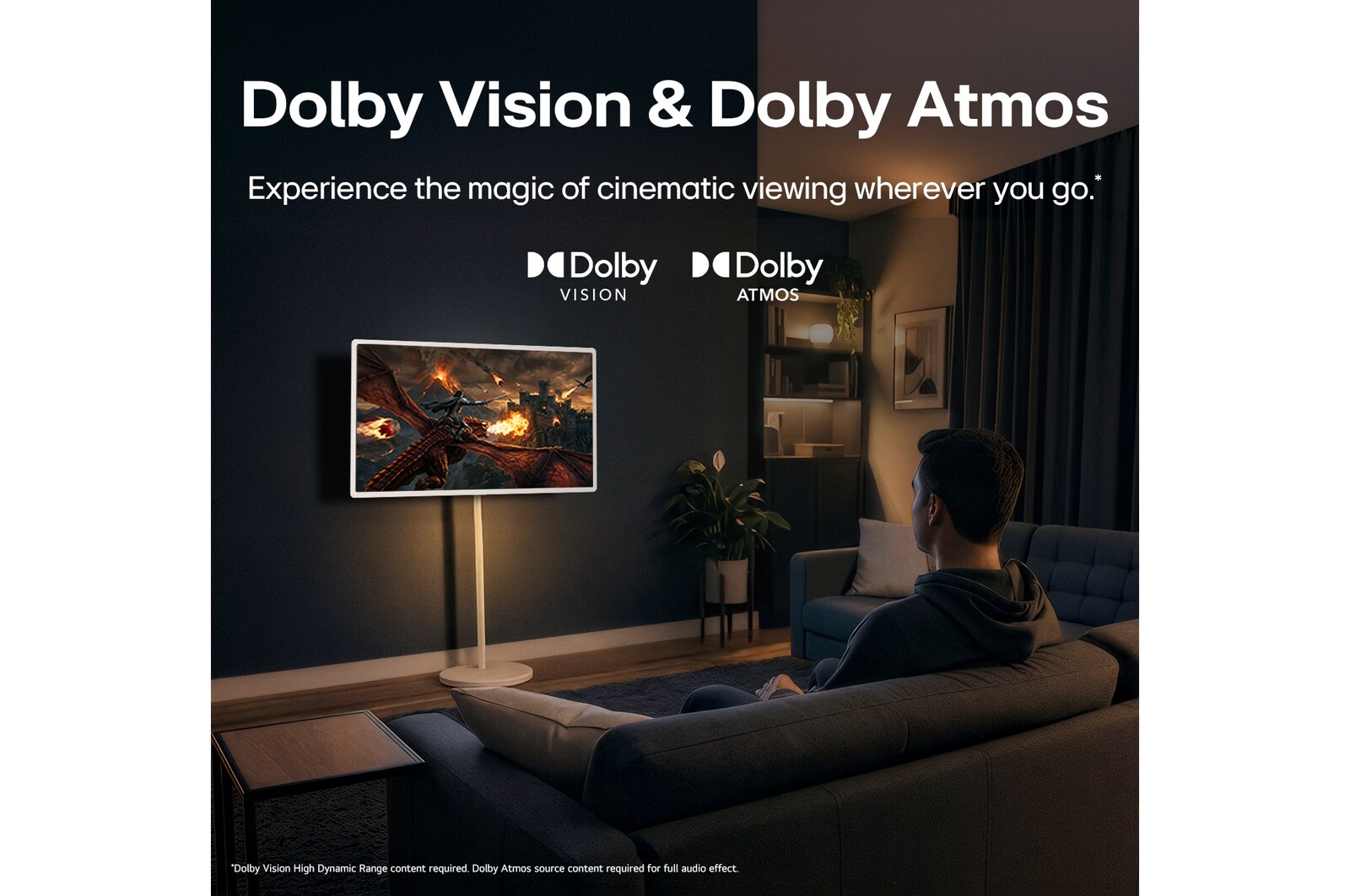 LG StanbyME 2 Max LX6 Movable Screen with Dolby Vision & Dolby Atmos shows a man watching a cinematic dragon battle in a dark room, where lifelike visuals and immersive sound create a theater-like experience at home.