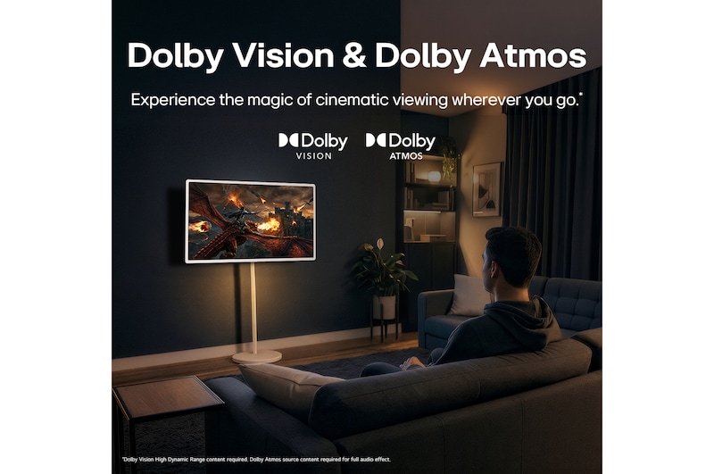 LG StanbyME 2 Max LX6 Movable Screen with Dolby Vision & Dolby Atmos shows a man watching a cinematic dragon battle in a dark room, where lifelike visuals and immersive sound create a theater-like experience at home.