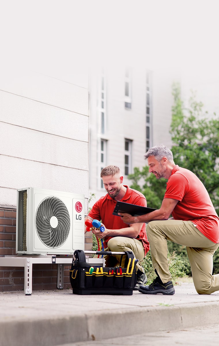 LG Air to Water Heat Pump THERMA V R290 Monobloc, black-colored outdoor unit is placed on the exterior green wall of the house.