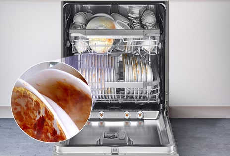 A free-standing dishwasher with the door fully open, revealing dirty dishes inside.