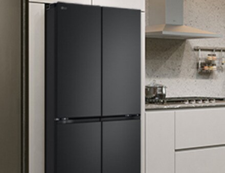 Modern kitchen interior with stainless fridge.