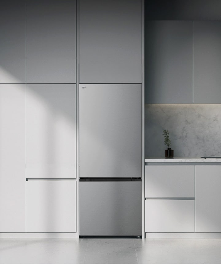 Stainless lg bottom freezer (GB-B400PS) built into grey cabinets beside marble countertop with induction cooktop and large window on right