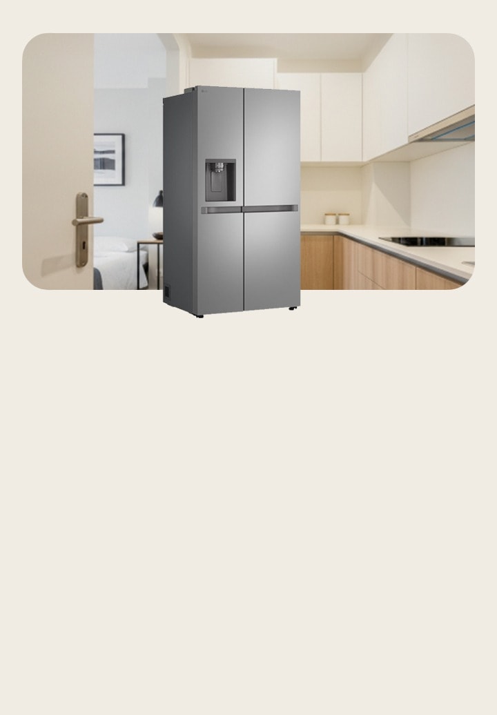 In a spacious kitchen, there is a large-capacity LG side-by-side refrigerator freezer. Behind it is a food pantry with cutlery on the right, an induction hob on the left, and a dining table at the back.	