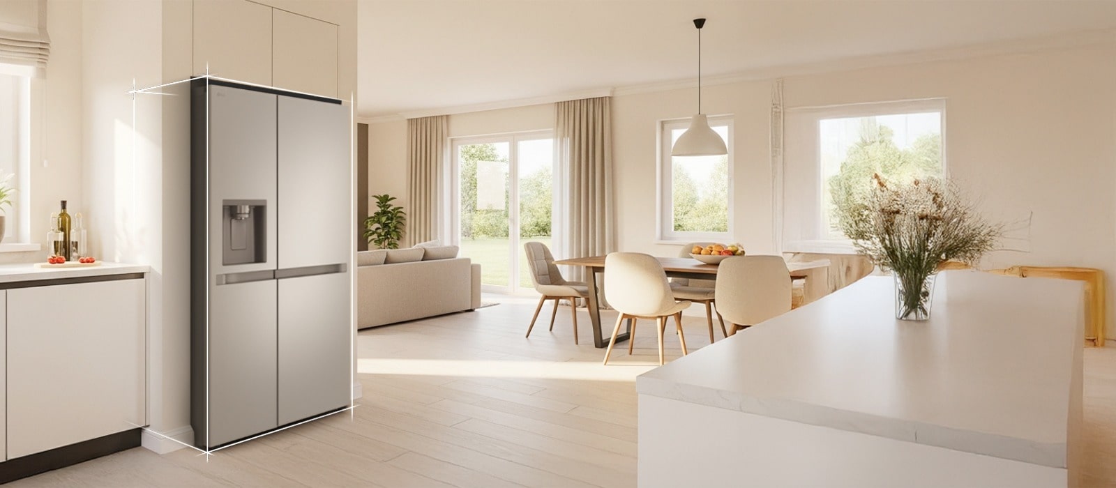 Bright beige-toned kitchen interior with a silver LG fridge freezer built into the left side. On the right, a dining table with flowers placed on top completes the scene.