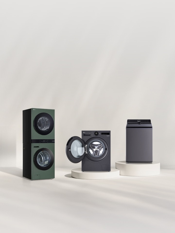 In front of the beige wall, there is the LG Wash Tower, front loading washer and top loading washe. On the right, you can see the forest view.	