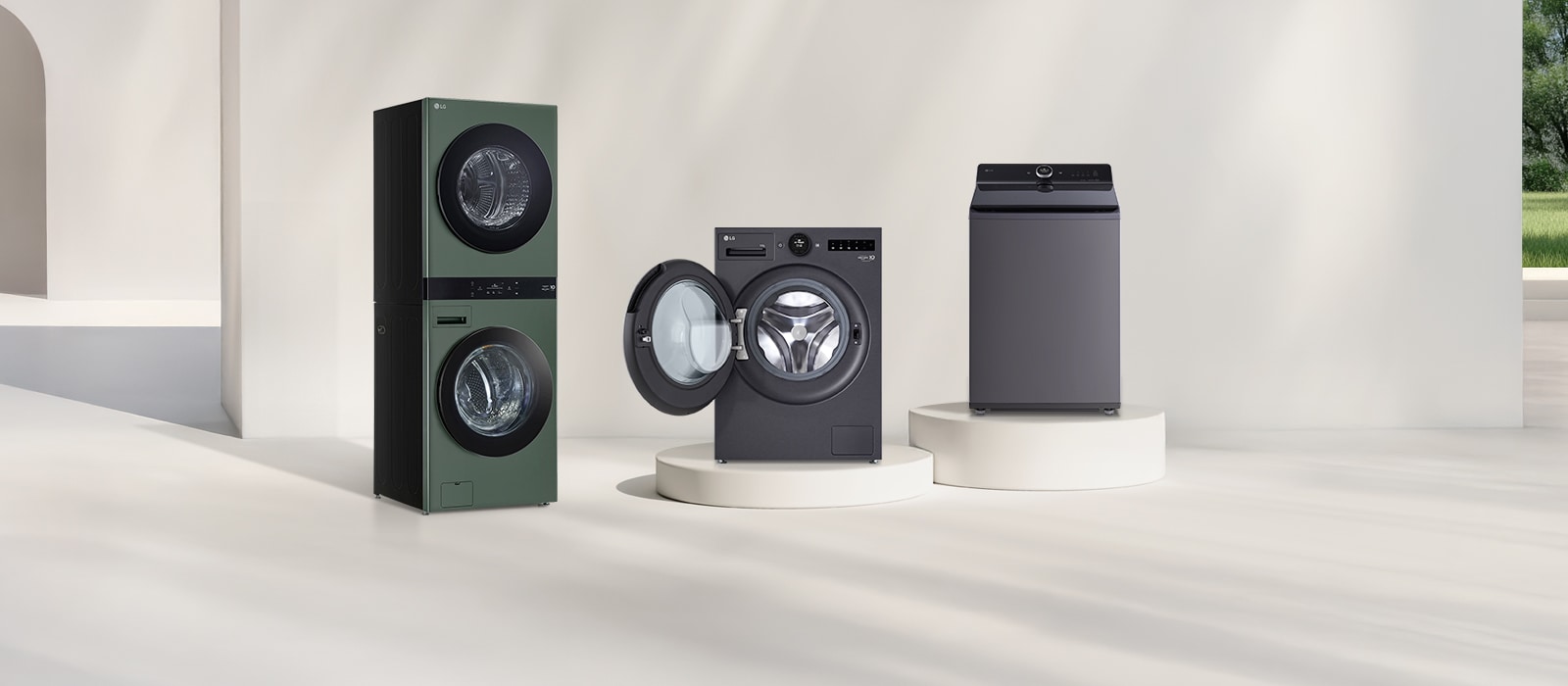 In front of the beige wall, there is the LG Wash Tower front loading washer, top loading washer, and twin washing machine lineup. On the right, you can see the forest view.