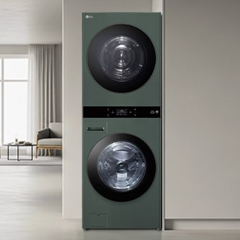 LG WashTower with green design, neatly installed. Surrounding it are organised clothes, baskets, and household items.	