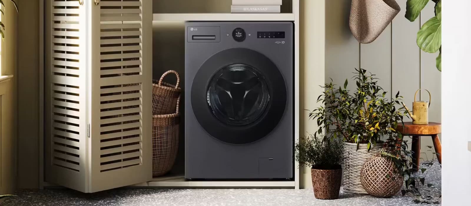 LG front load Washing Machine installed inside a beige cupboard on the left, with a plant placed on the right.