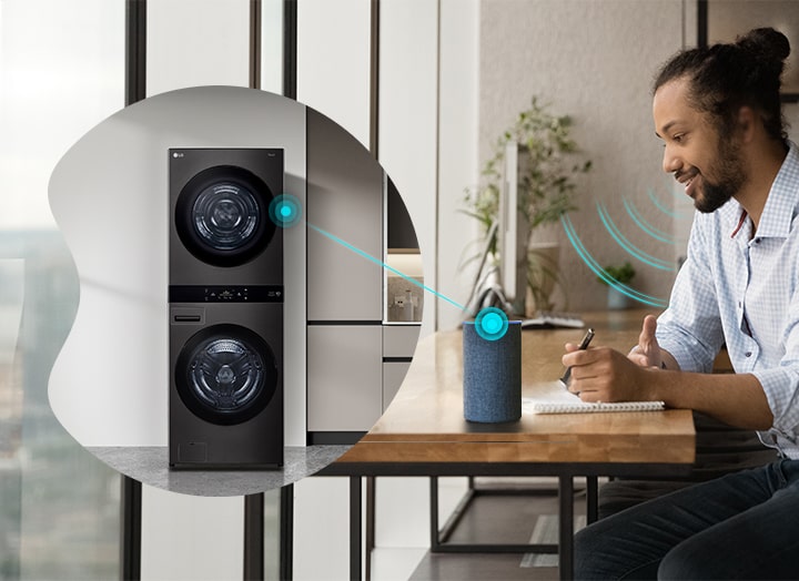 A man controlling the LG WashTower with voice assistant