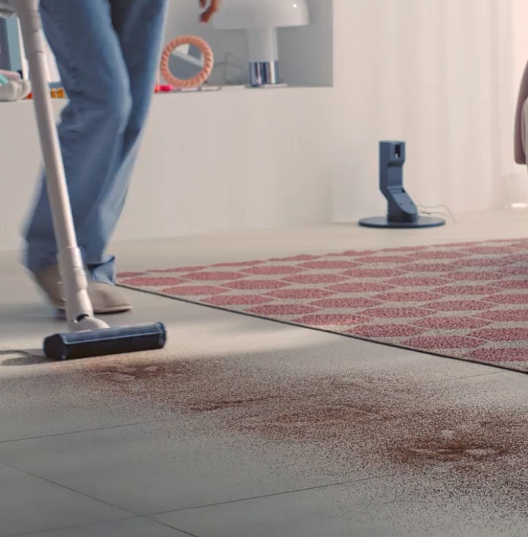 Video of LG A9-ACE vacuum cleaning across scattered dirt on the floor
