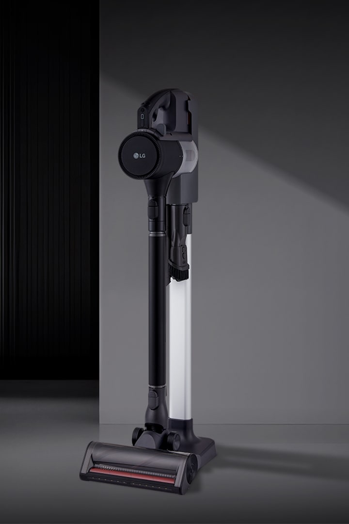 A9L vacuum standing upright in a modern room setting.