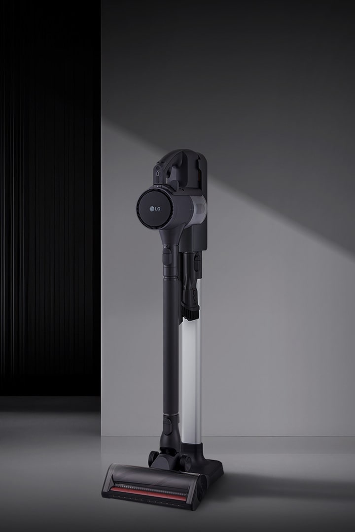 A9L vacuum standing upright in a modern room setting.