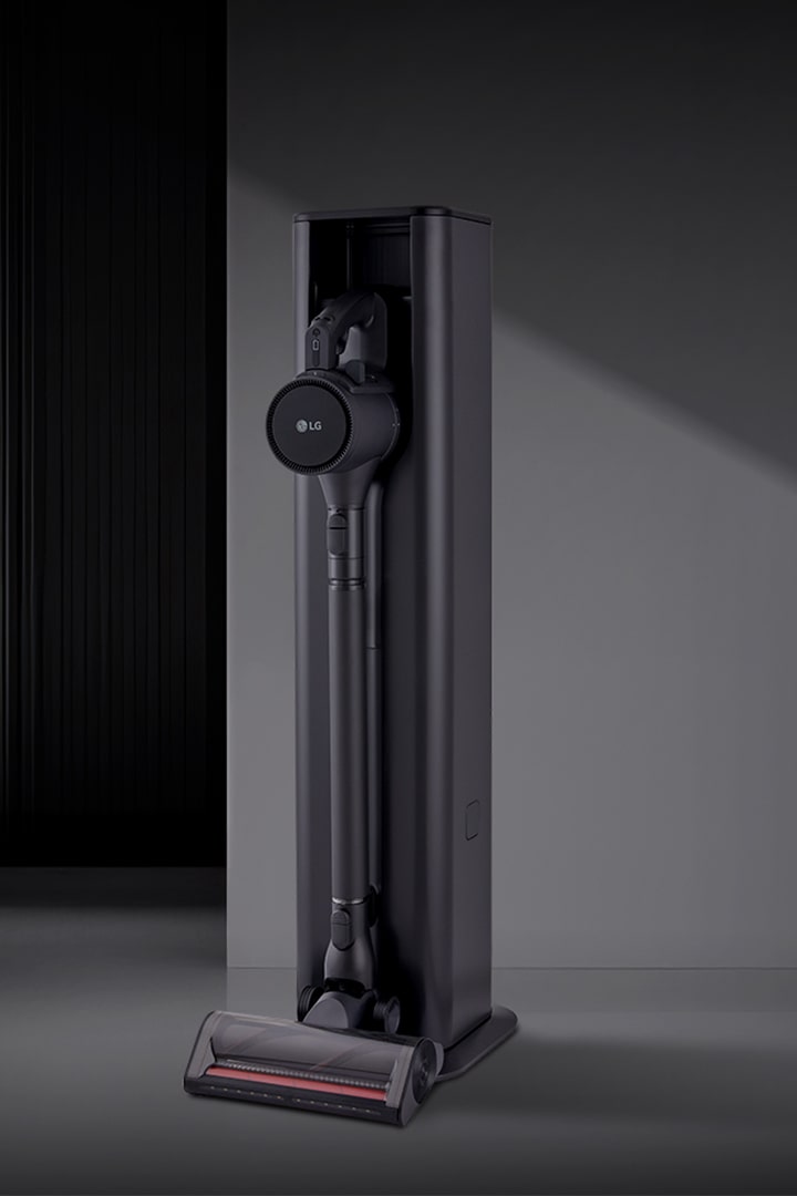 Tower vacuum in dark living space.