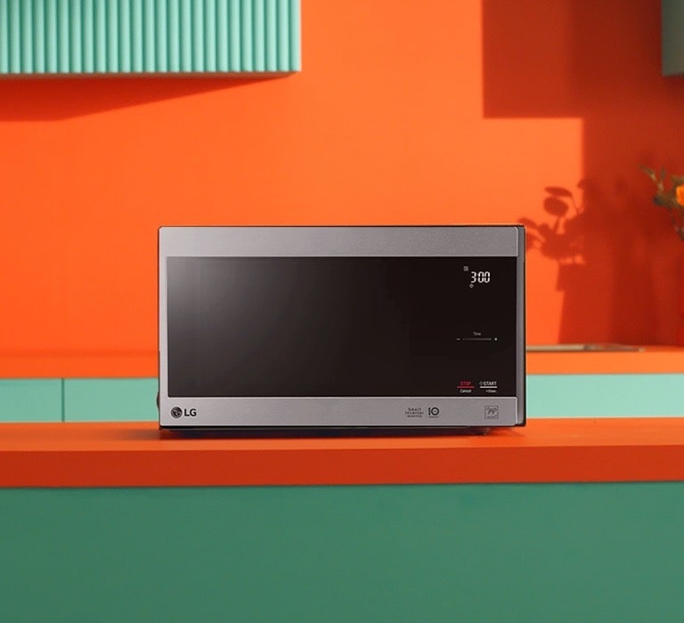LG Neochef® microwave oven placed in bright orange and green modern design kitchen.