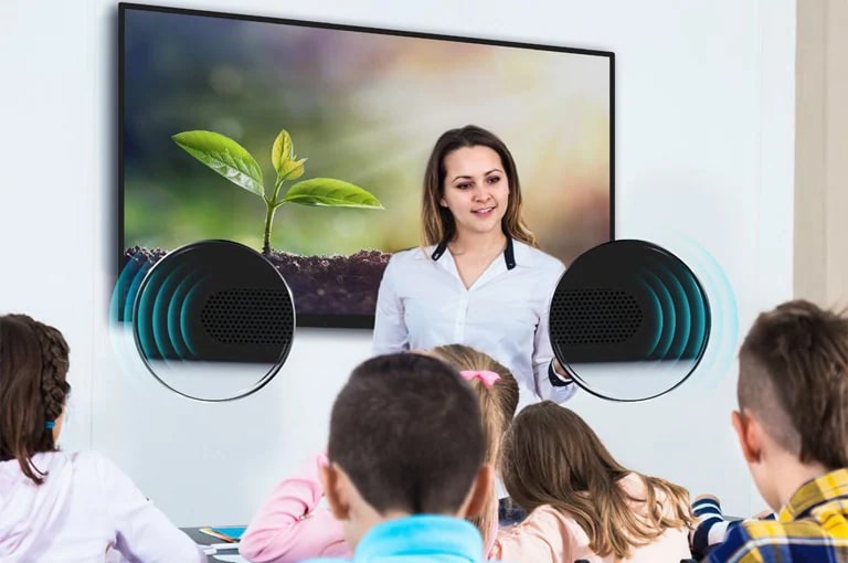 The teacher is teaching the students in class and the students are listening to the sounds from the TR3DJ.