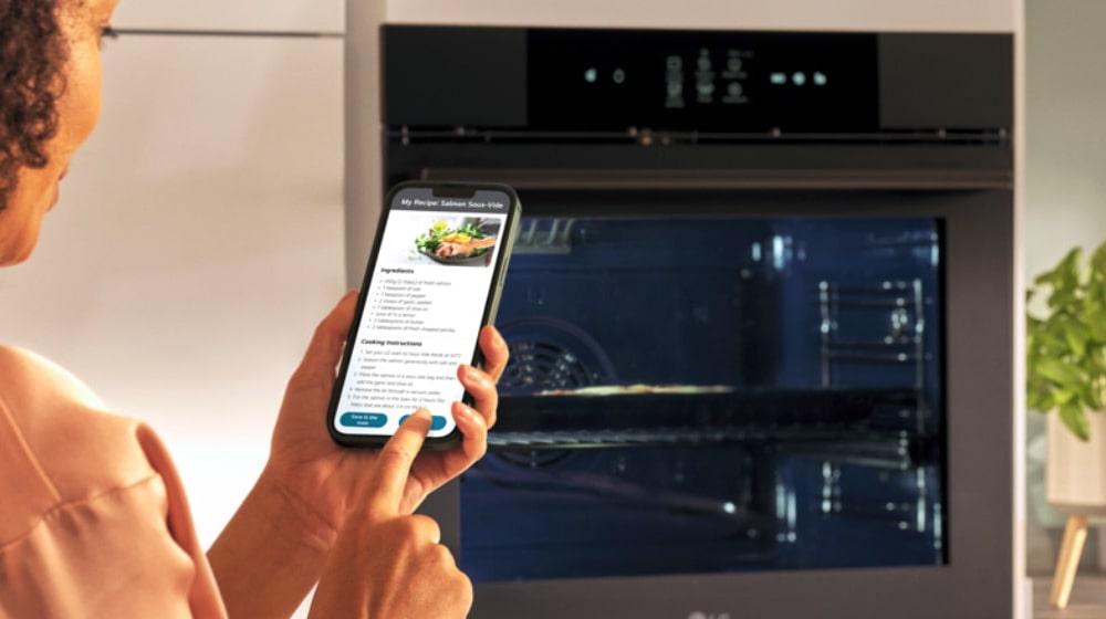This is an image of a woman looking at a food recipe on her smartphone.