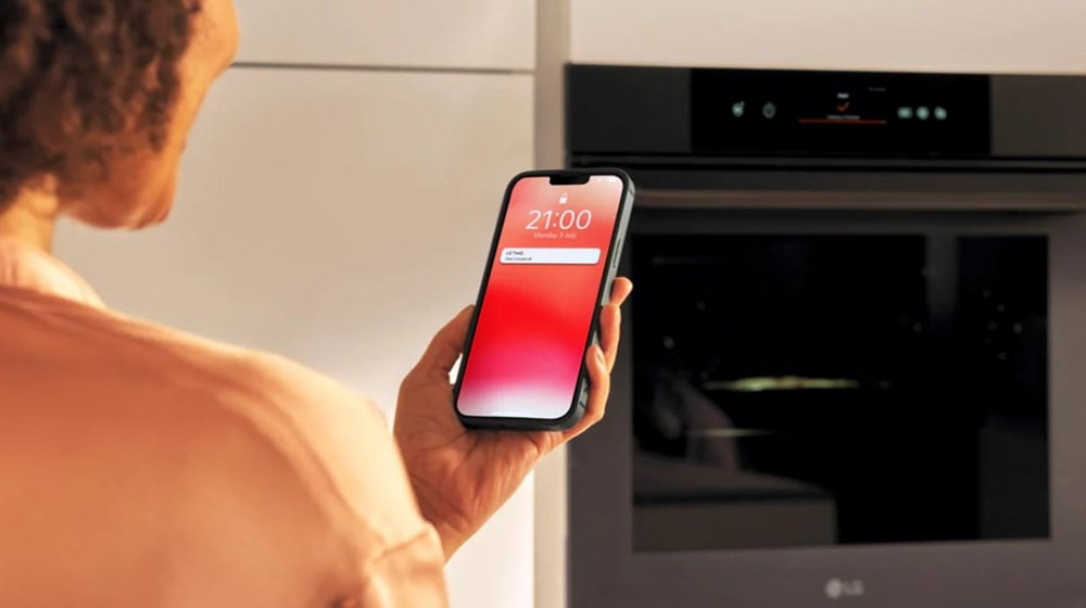 This is an image of a woman looking at a food recipe on her smartphone.
