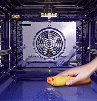 The image of wiping the inside of the oven with a cloth.