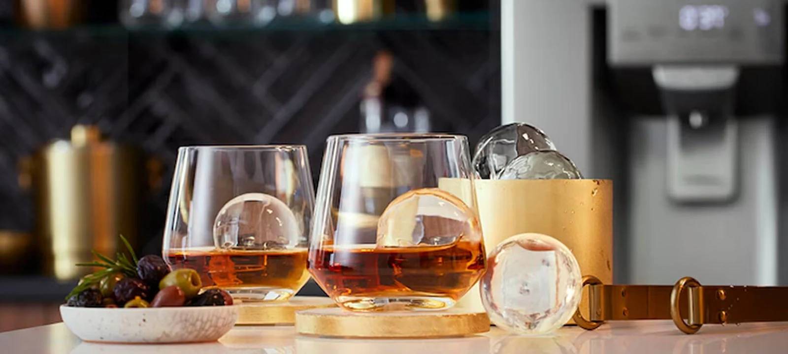 An innovative refrigeration solution for a man cave, producing slow-melting round ice spheres, perfect for a variety of drinks.