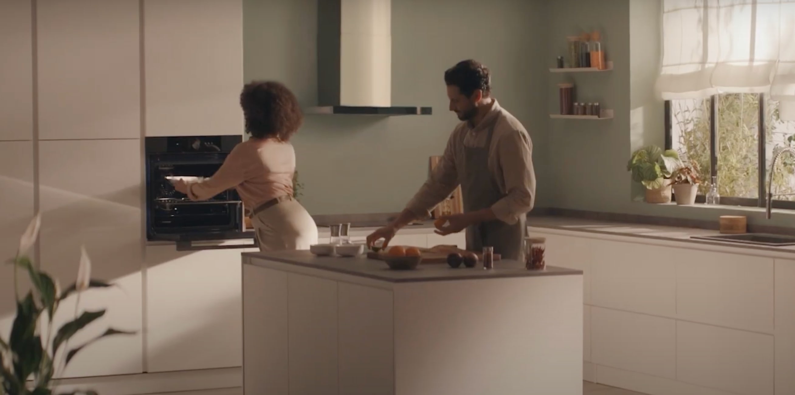Couple preparing food in a modern kitchen. 