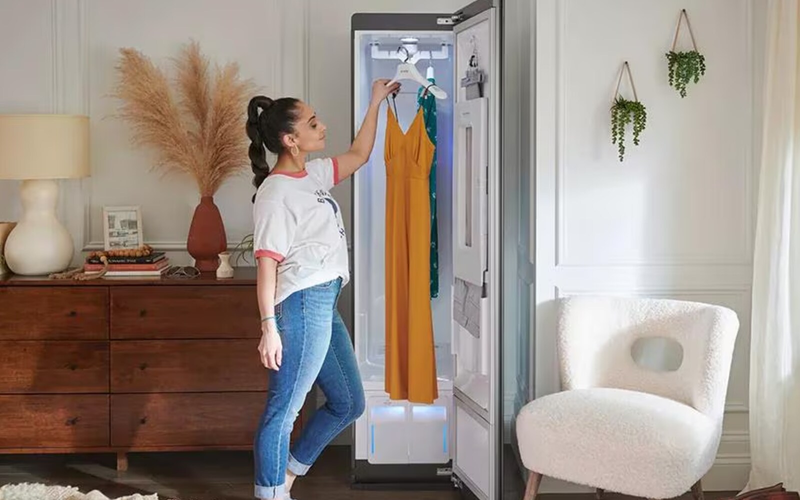 A woman selecting a dress from the LG Styler, highlighting how the device helps maintain the freshness and quality of garments.