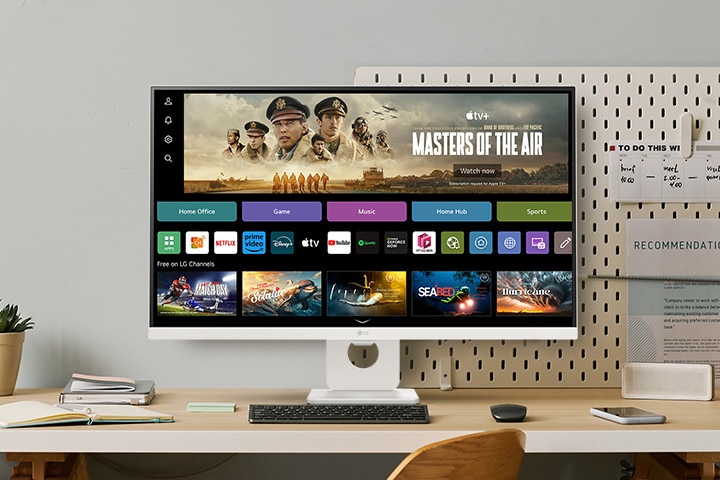 The video shows a smart monitor placed on the desk, with the screen transitioning in the order of webOS, home office, music, game, fitness, and sports.