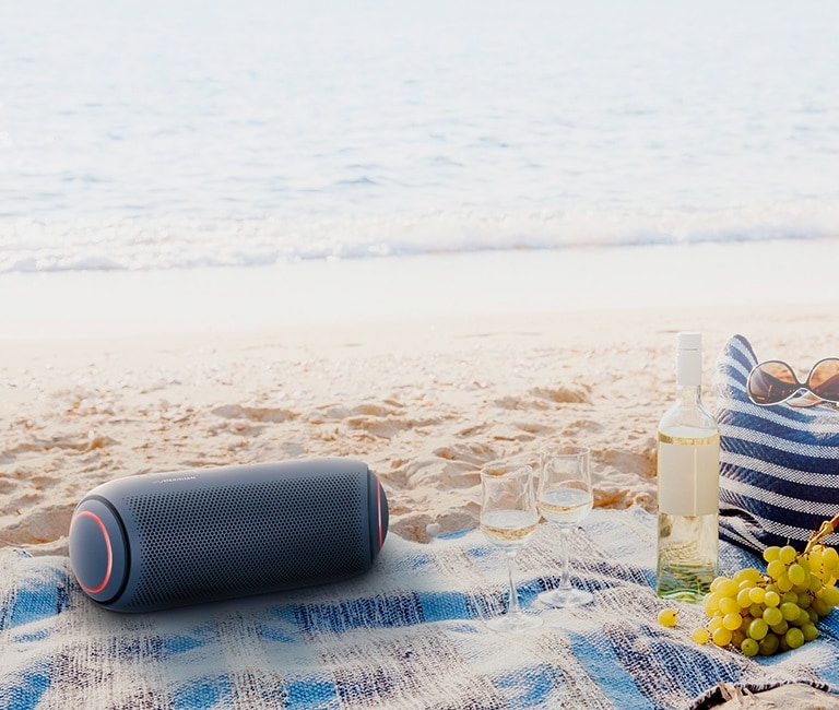 Light shines from the surroundings and the front of the XBOOM Go with blue lighting on either end is visible.