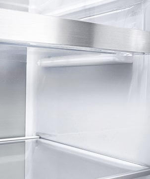 A diagonal view of the shelf with metallic paneling on the interior of the refrigerator.